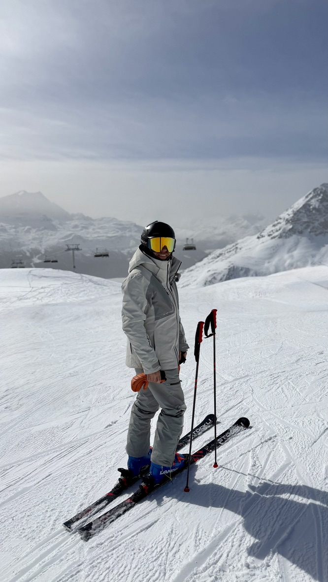 Adam on his skis on a snowy mountain piste