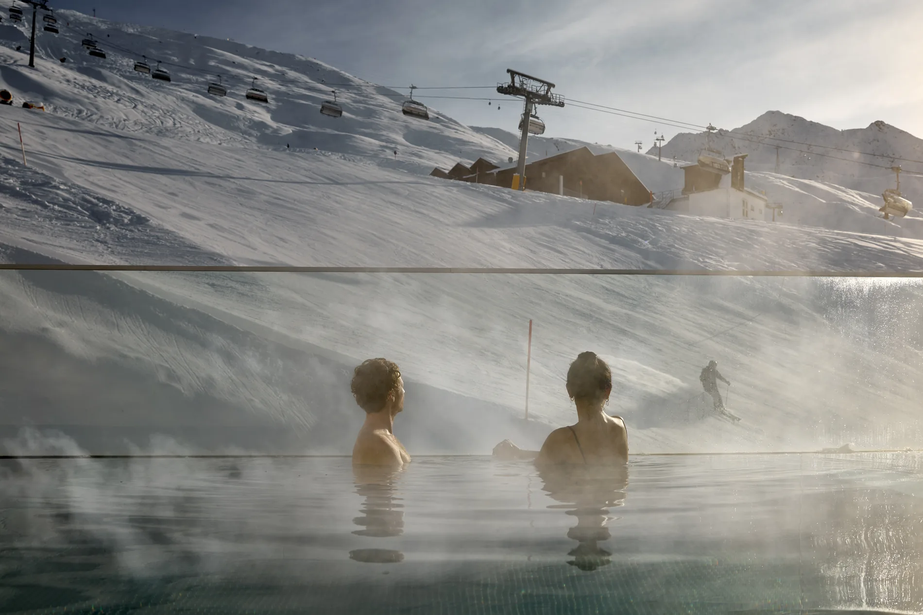 Guests in the heated outdoor pool overlooking Hochgurgl’s ski slopes